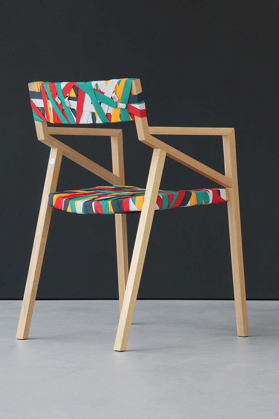 Gorgeous chair with a solid wood frame and wrapped in colorful suspenders