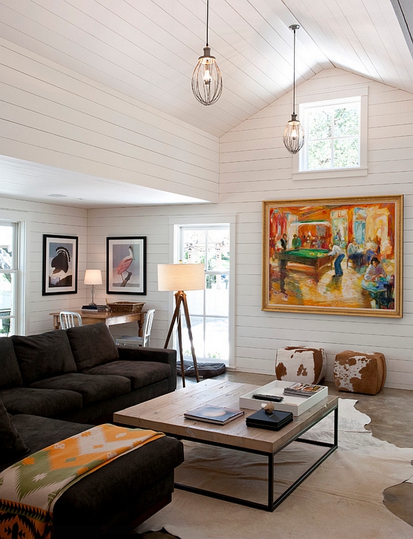 Gorgeous tripod lamp with wooden legs in a breezy and relaxing living room in white with a coastal vibe