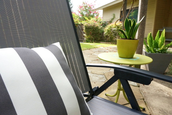 Gray and white striped pillow on a modern lounger