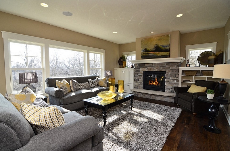 Gray and yellow color palette lends sophistication to this contemporary living room with a fireplace