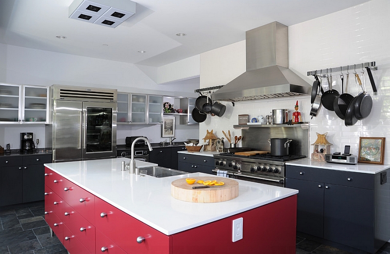 Kitchen with white countertops, black shelves and a red kitchen island