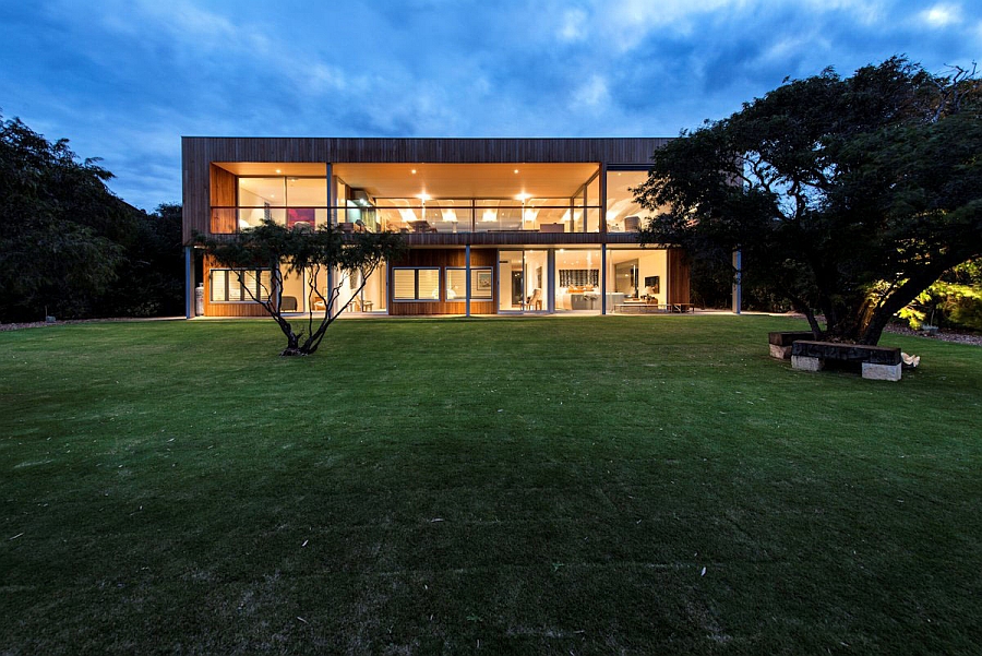 Large glass doors and windows connect the interior with the backyard