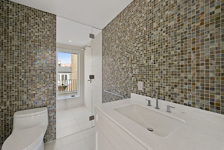 Lavish bath with a glass shower area and colorful tiles