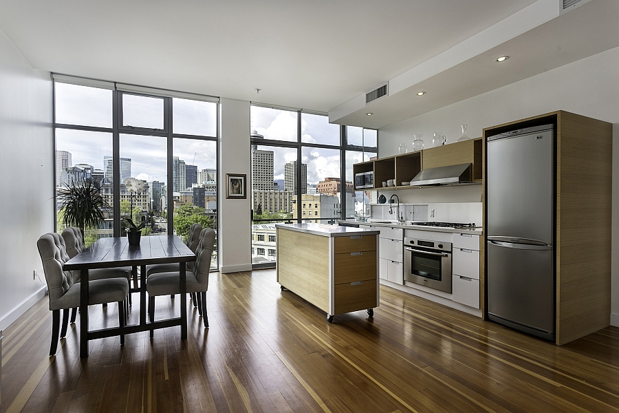 Lovely wooden floors and the smart kitchen island on wheels lend inviting warmth to the space