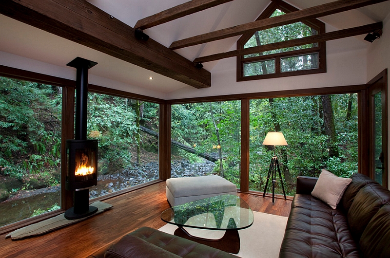 Many shades of nature offer the perfect backdrop for this amazing living room with glass walls