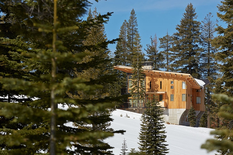 Natural wood and concrete exterior of the Corw's Nest stands out in the snow-covered backdrop