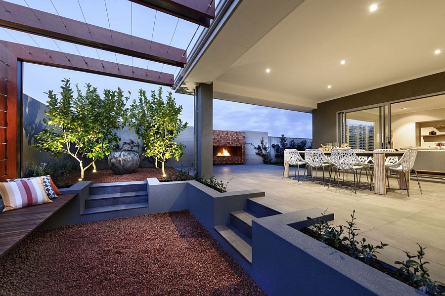 Outdoor dining area and sunken lounge lit up by goregous LED lights