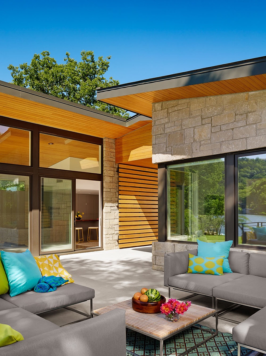 Outdoor lounge with plush sofas in gray and yellow and turquoise accent pillows