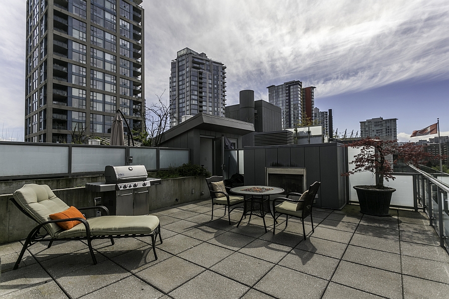 Rooftop deck complete with an outdoor kitchen, lounge and stunning views of Vancouver