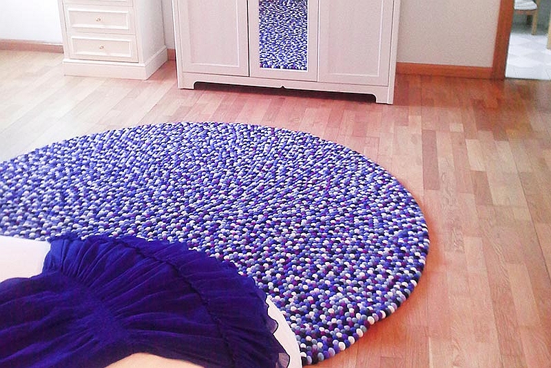 Round purple and white felt ball rug