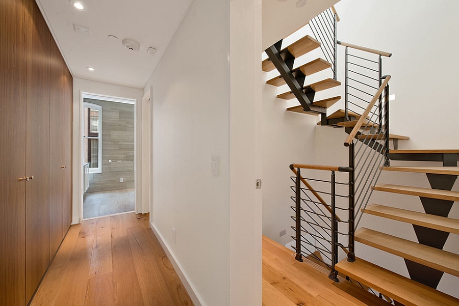 Sleek and space-conscious staircase acts as the backbone of the NYC family house