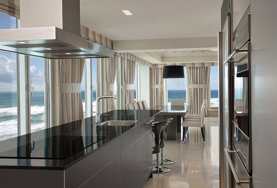 Sleek kitchen in black with state of the art appliances and mesmerizing ocean views