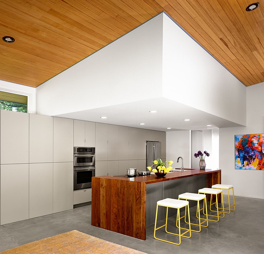 Smart contemporary kitchen with a spacious island and colorful bar stools