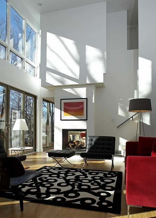 Smart contemporary living room in white Barcelona chair and stool in black and DWR tripod lamp