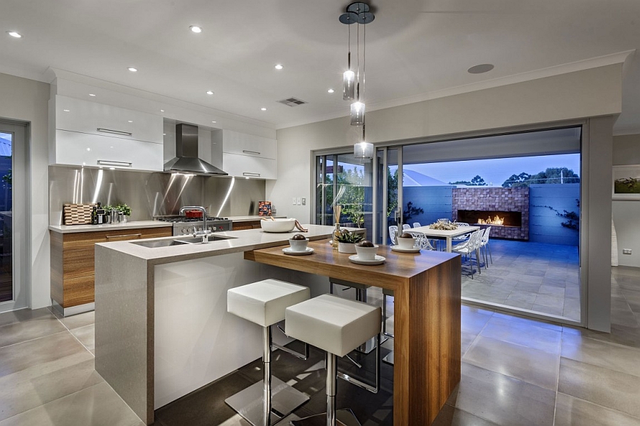 Smart kitchen with an extended addition to the kitchen island that serves as a dining table