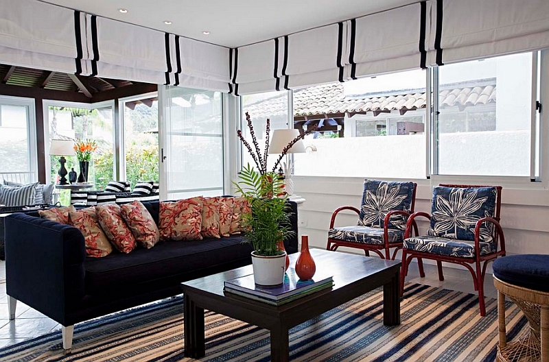 Smart use of roman shades throughout the beach style living room