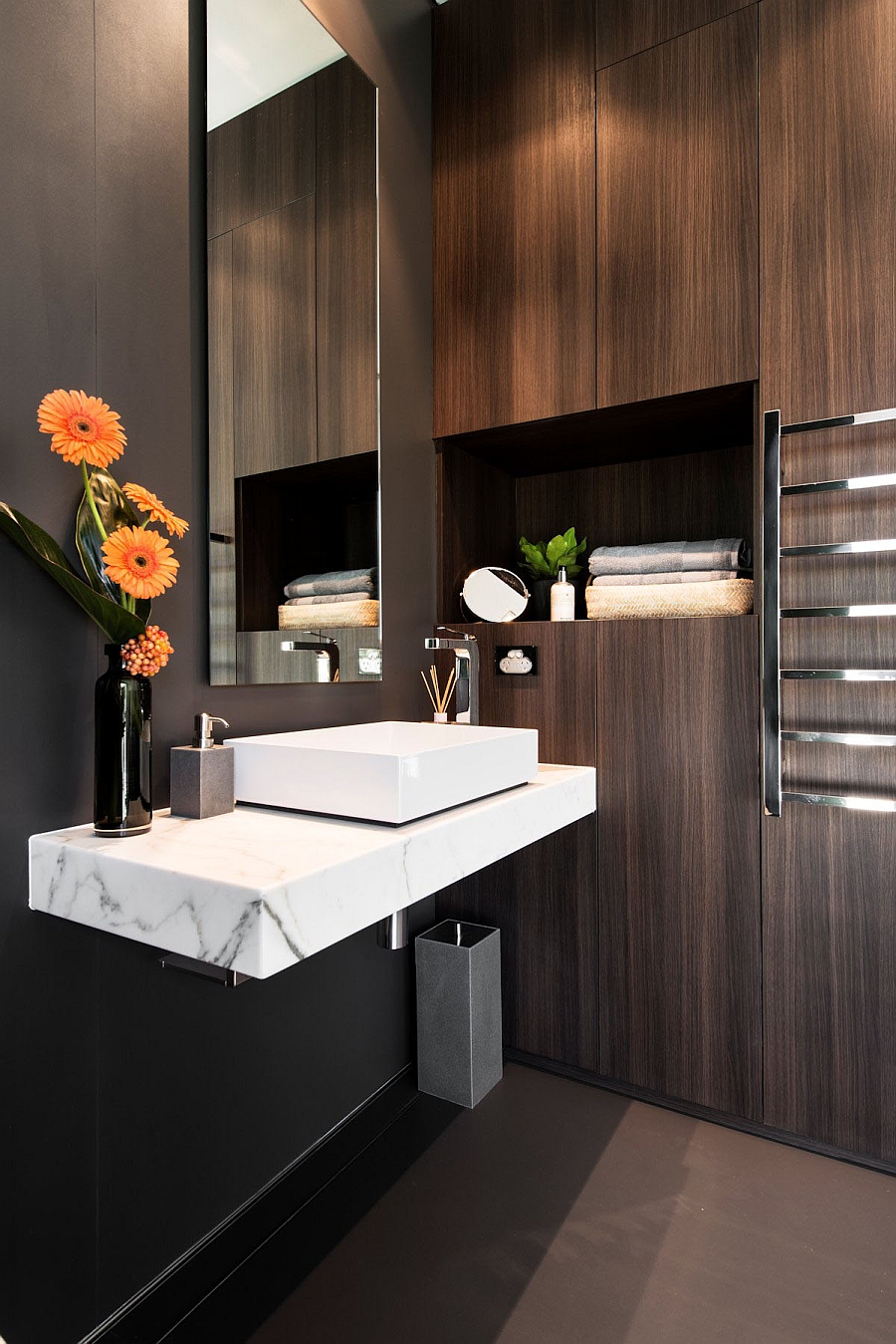 Stunning bath with floating marble vanity and wooden backdrop