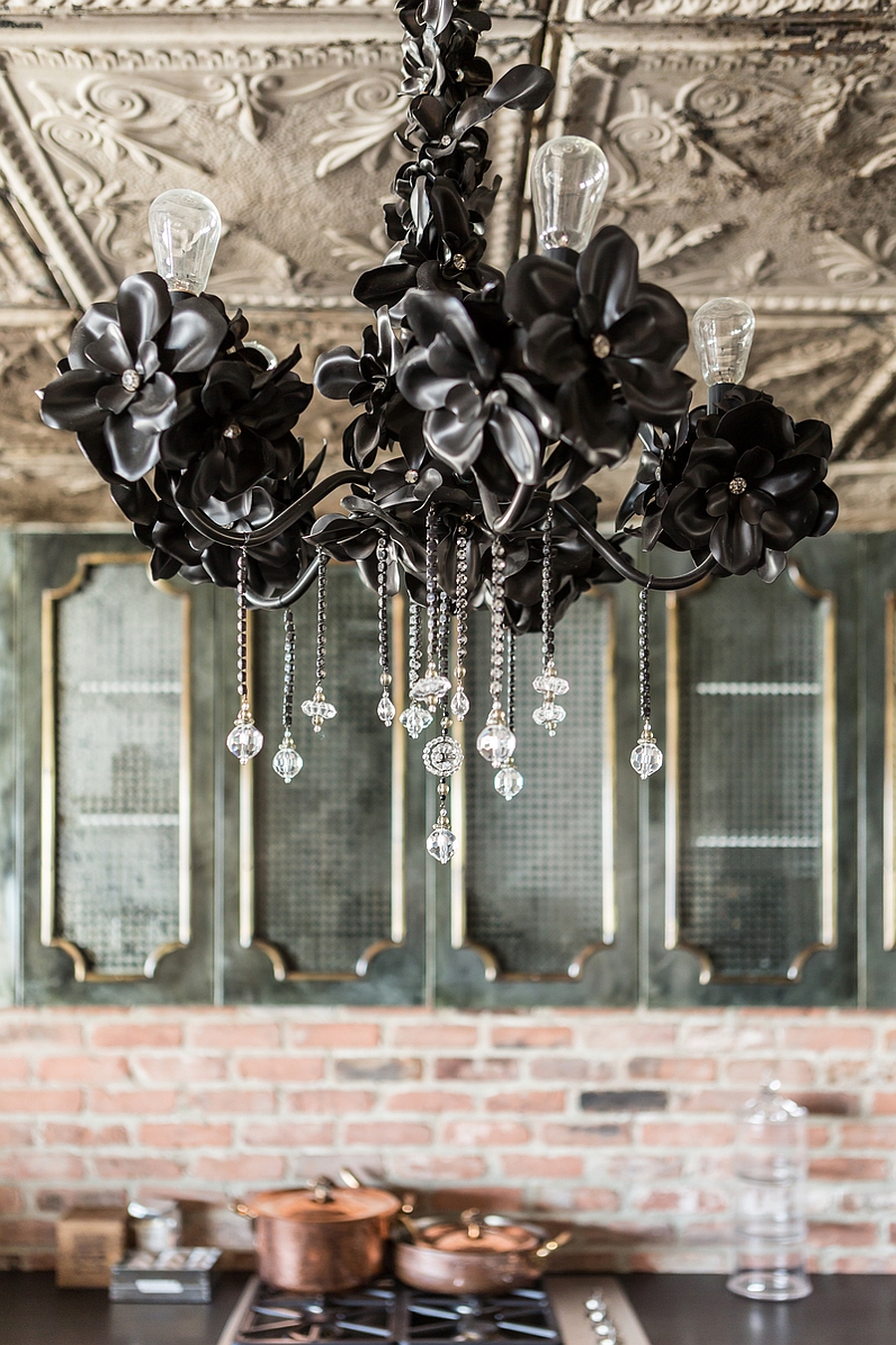 Stunning chandelier and a roof with intricate patterns adds class to the space