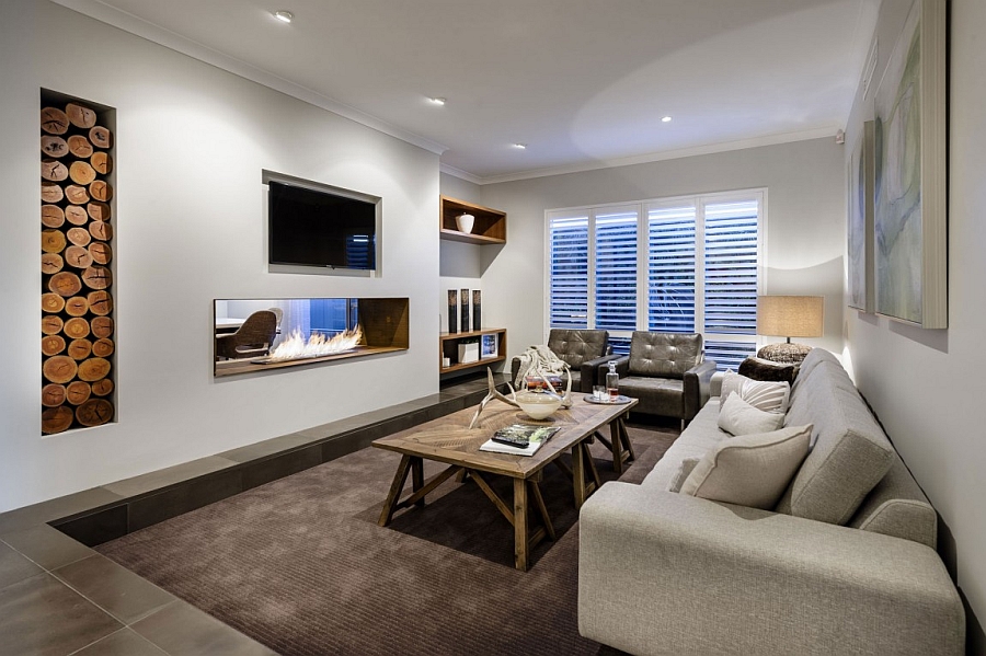 Sunken seating area next to the living room with a two-sided fireplace