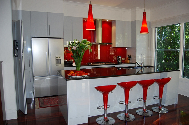 The Bombo bar stools, backsplash and pendants bring bright red to this kitchen