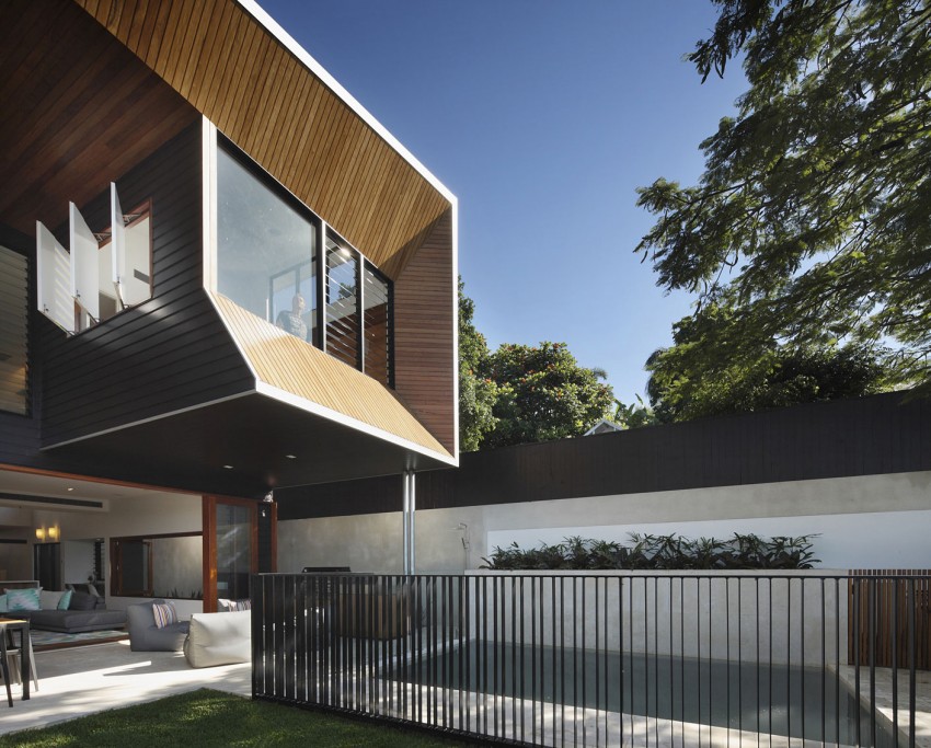 Top level crafted in wood and glass adds to the drama of the house