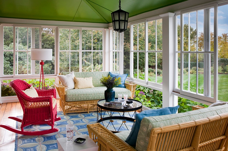 Transitional porch with a colorful tripod lamp in red