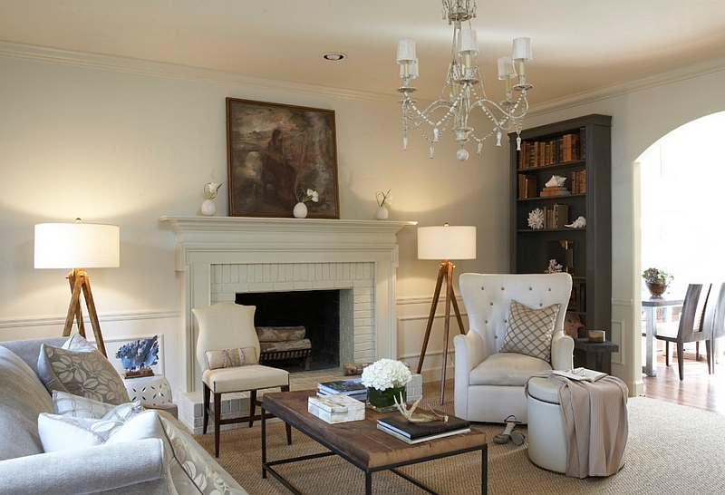 Twin Tripod Floor Lamps by Sandy Chapman grab the attention in this transitional living space