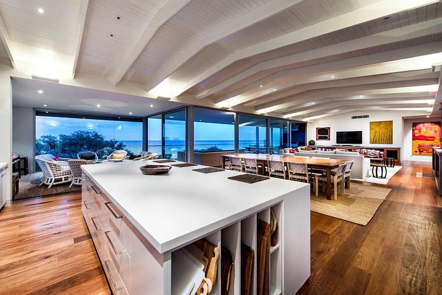 Vaulted ceiling and exposed wooden beams add to the beach style of the house