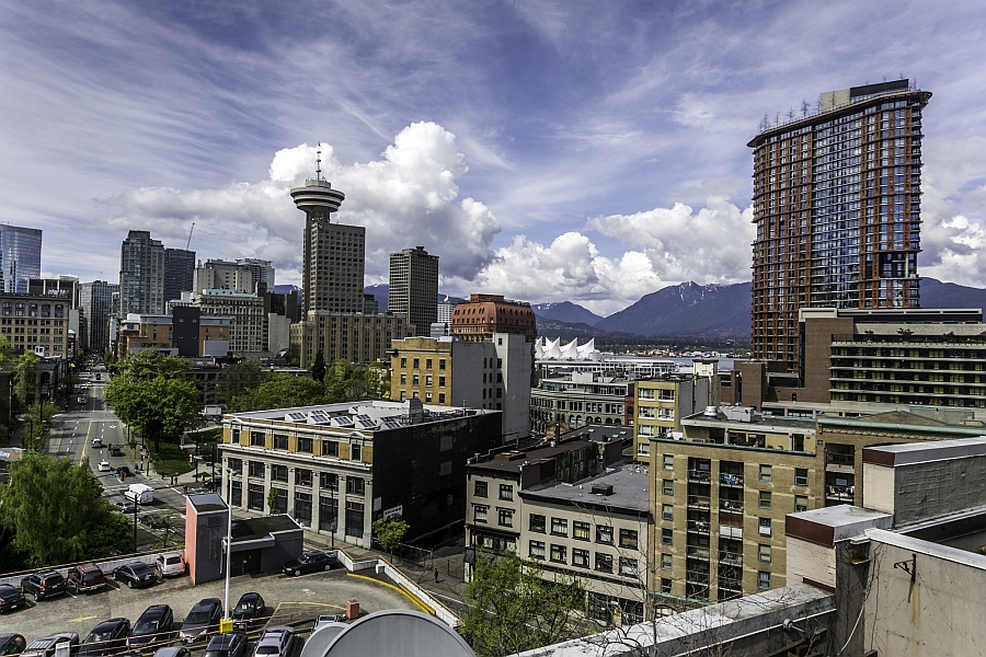 View of the Vancouver city skyline and the mountains in the distance from the rooftop deck