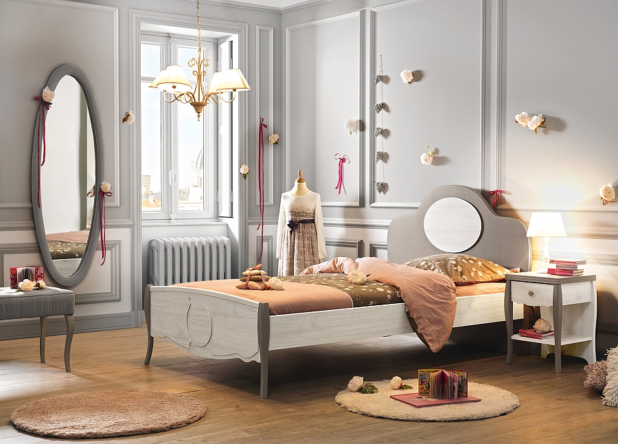 Wall-mounted oval mirror adds to the timeless look of the elegant girls' bedroom