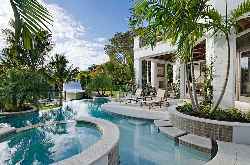 White and blue along with some tropical plants helps set the mood in this backyard