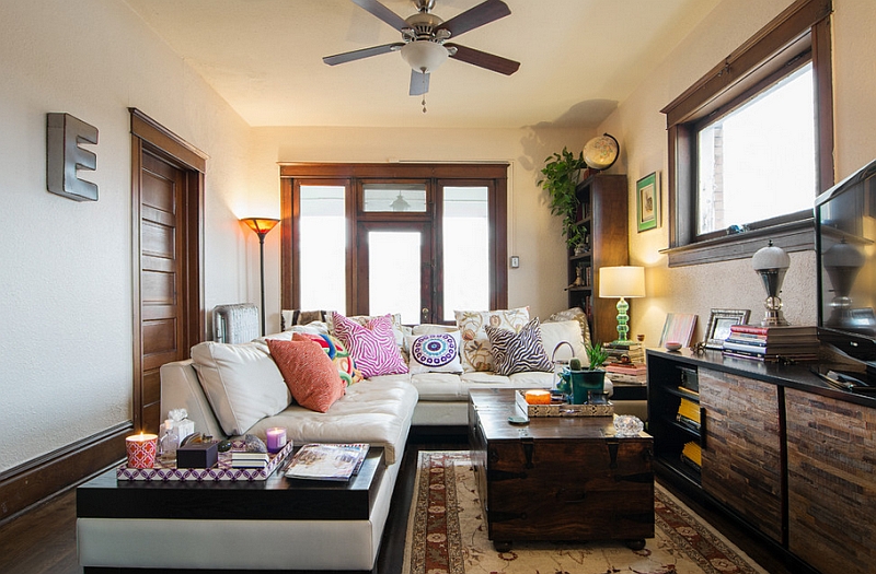 Wooden media console and large trunk that doubles as coffe table add to the appeal of the living room