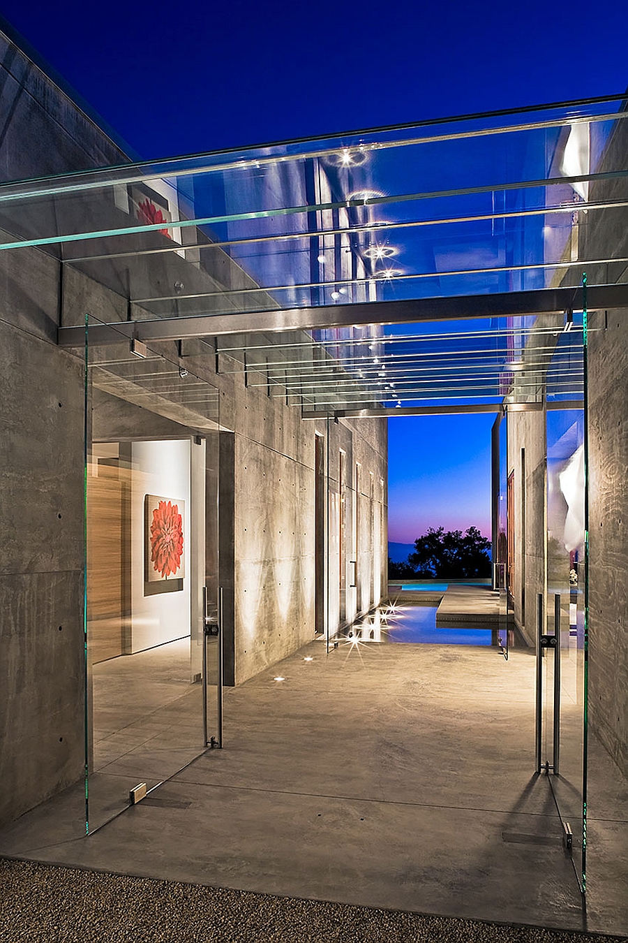 Amazing glass entry pavilion between the living and the carport units