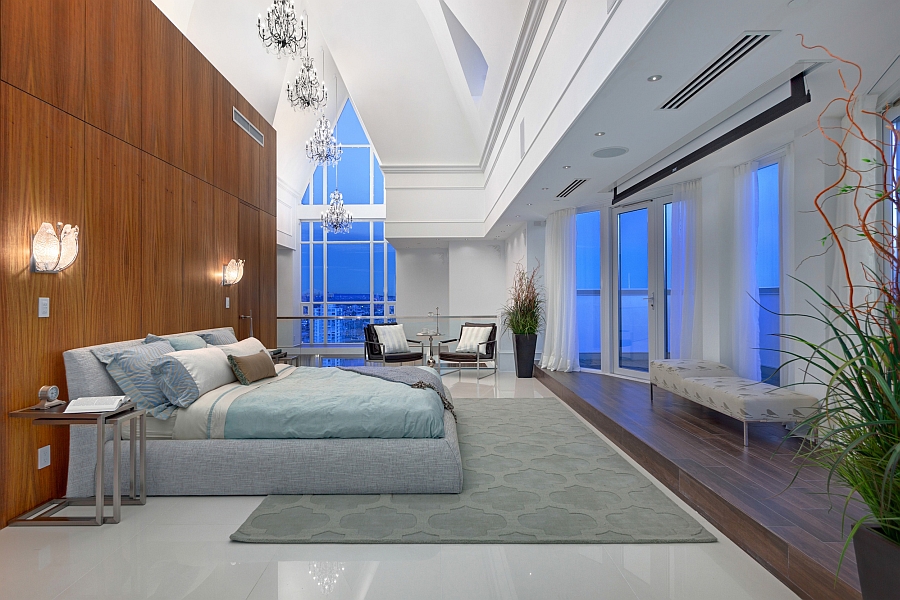 Amazing lighting and cathedral ceilings shape the lavish master bedroom