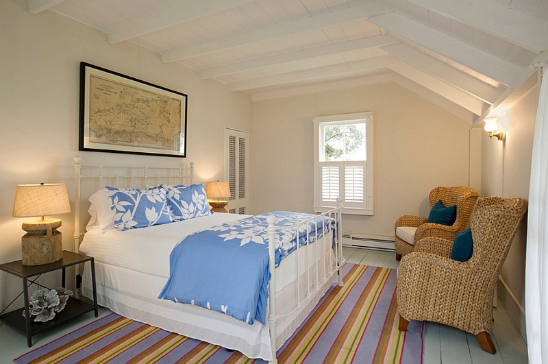 Beach style bedroom makes the best possible use of the distinct contours of the room