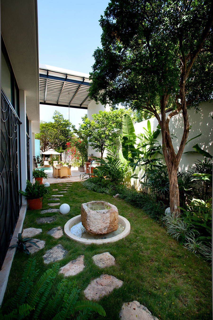 Beautiful garden with a rock pathway and water feature at its heart