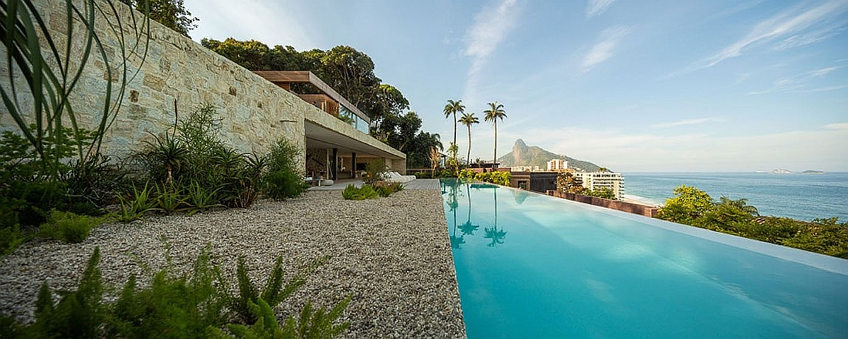 Beautiful house in Brazil with a lavish pool overlooks the ocean in the distance