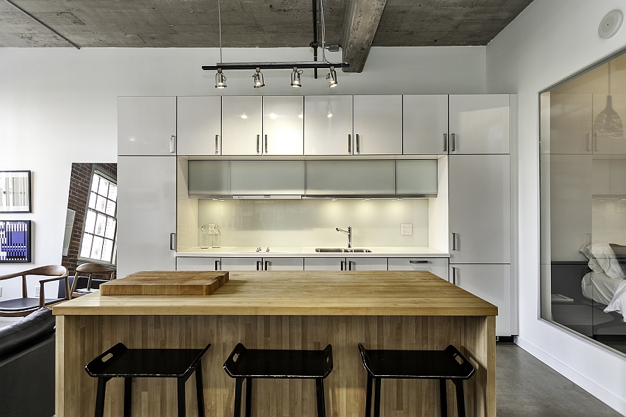 Beautiful kitchen with exposed concrete ceiling and track lighting