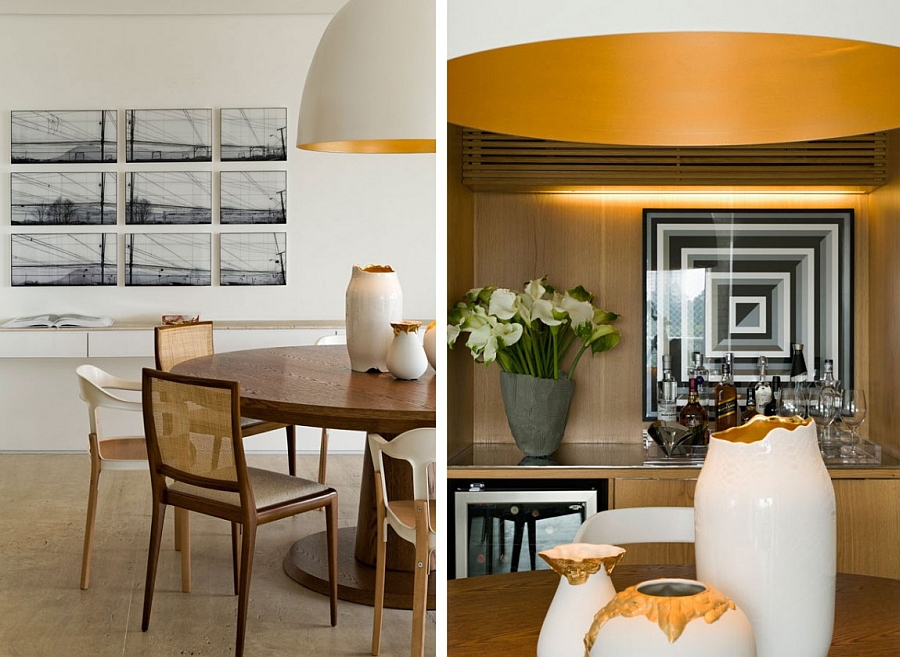 Beautiful vases in white and golden yellow complement the pendant light above