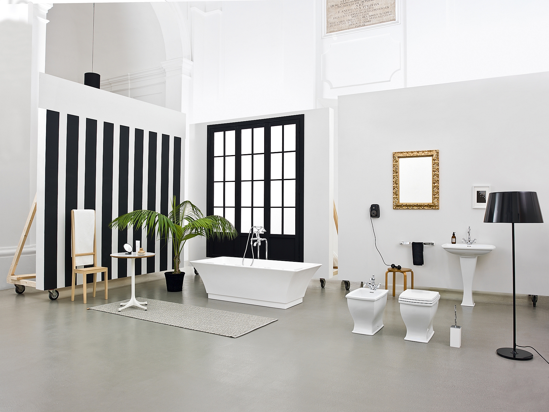 Black and white stripes and pops of gold bring sophistication to the trendy bathroom