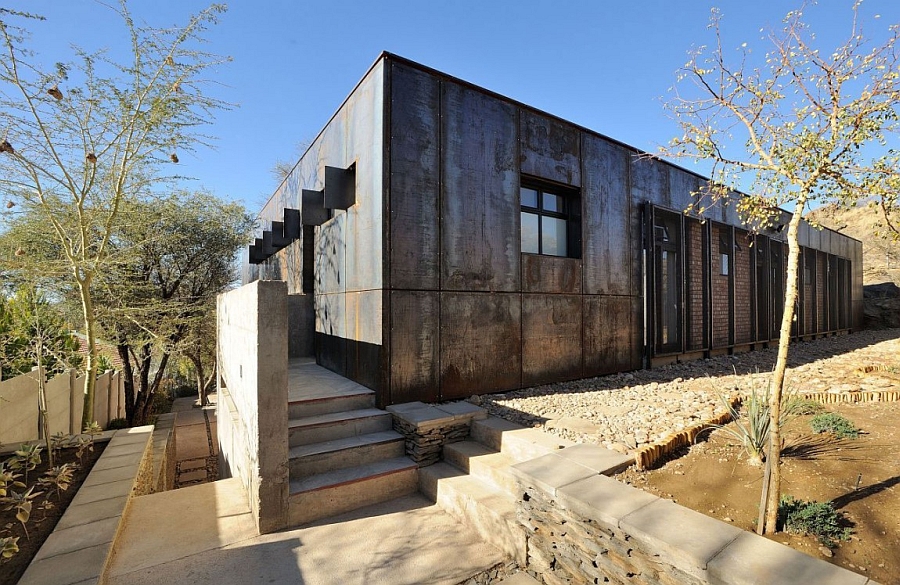 Brick, mica stone and rusted steel shape the exterior of the house