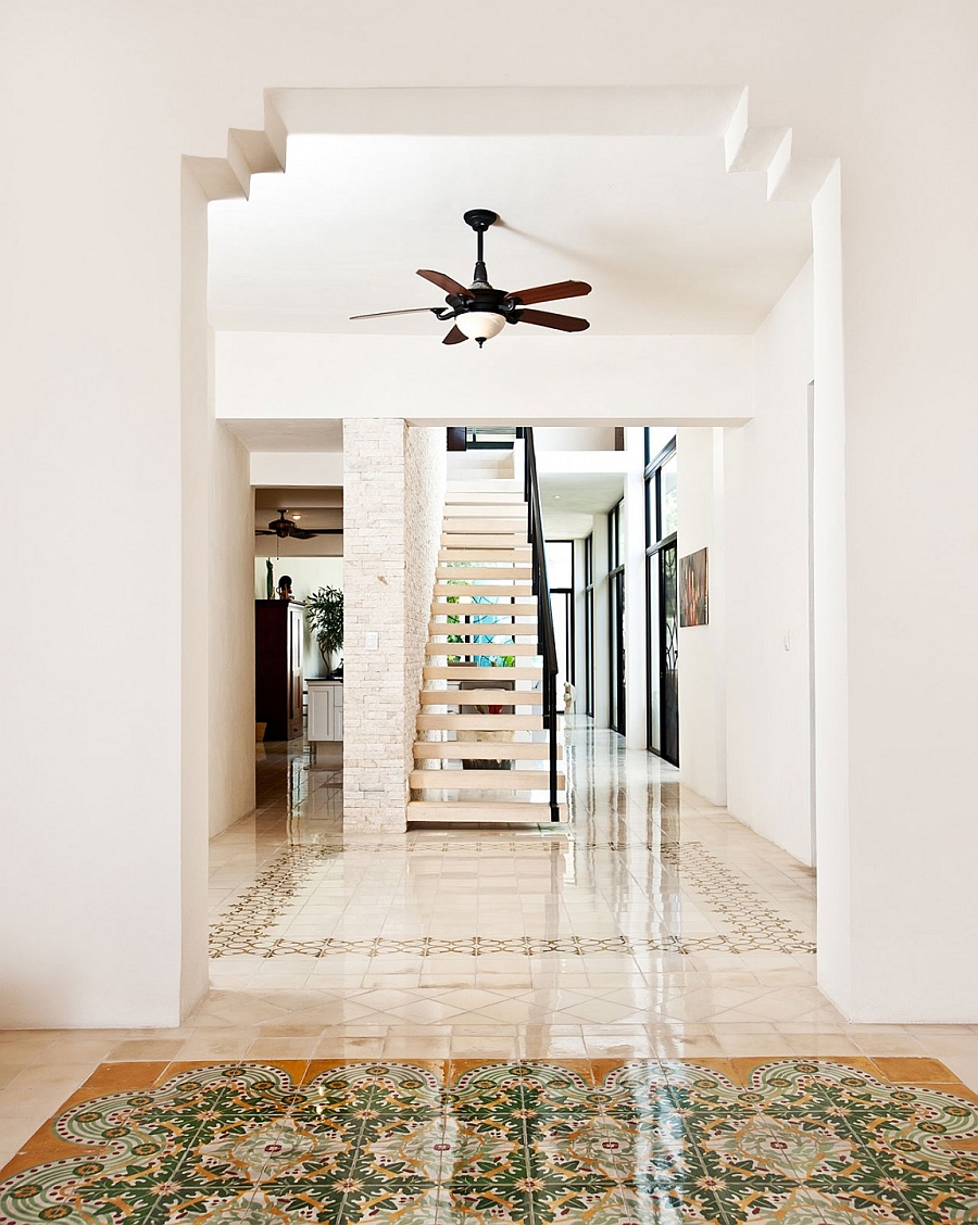 Brick wall next to the staircase adds textural contrast to the interior