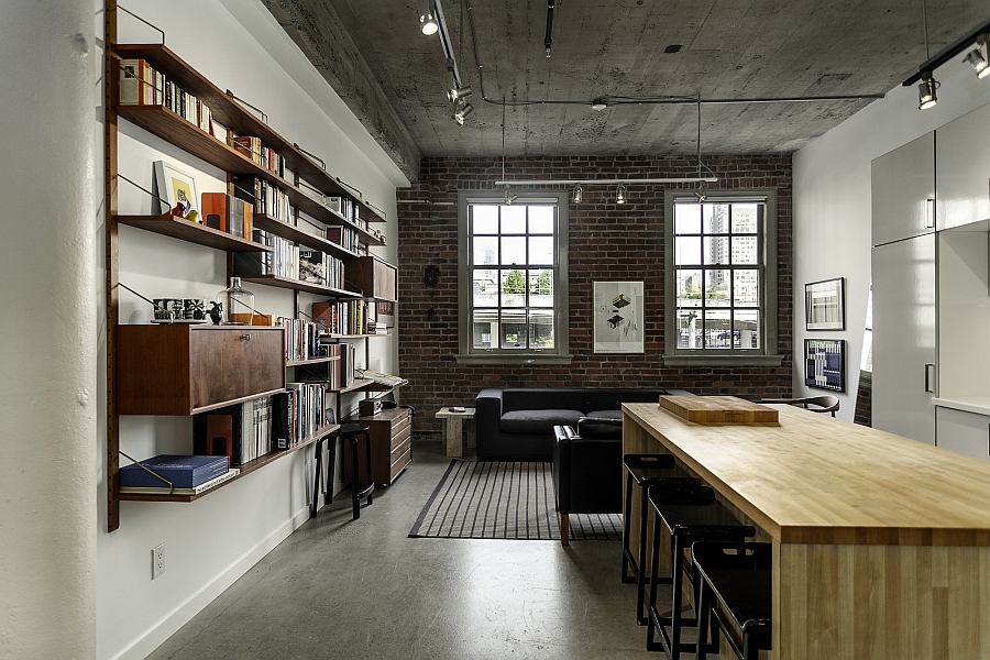 Brick walls and exposed concrete preserve the original appeal of the renovated apartment