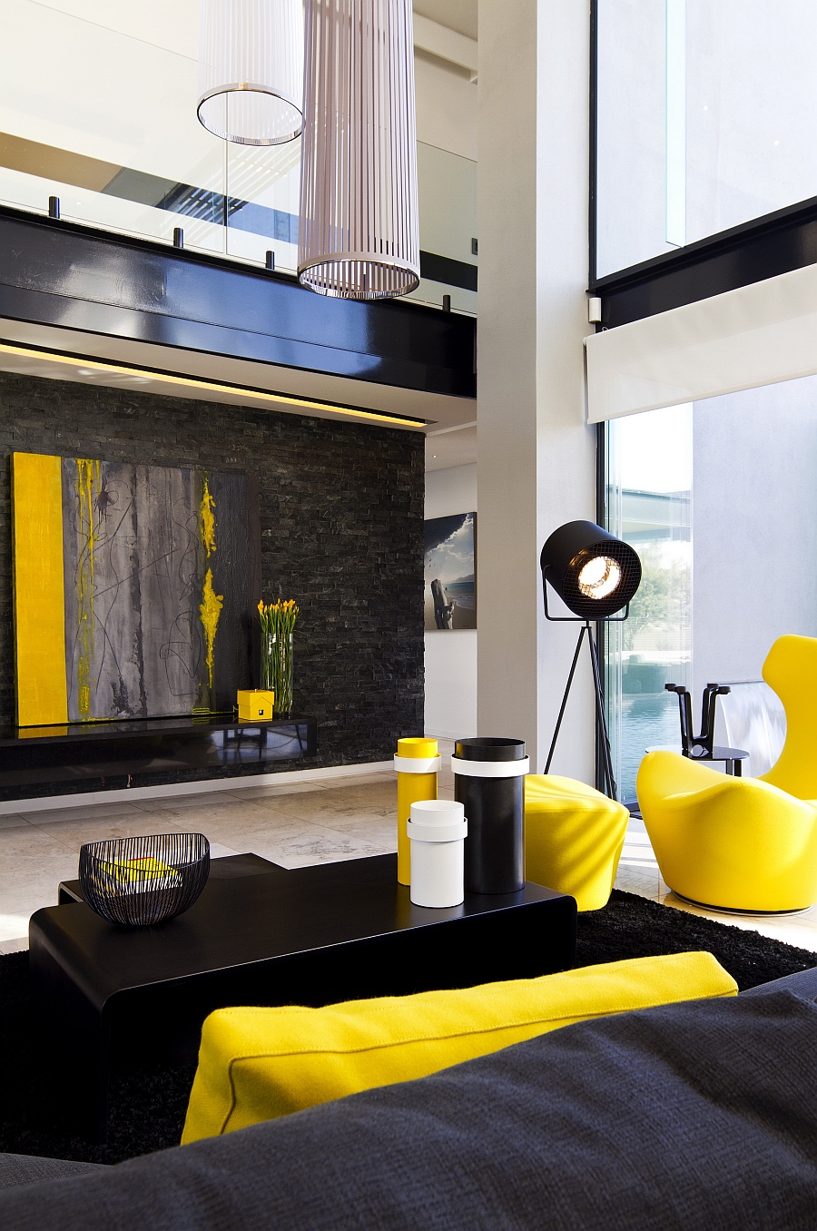 Bright yellow accents enliven the contemporary living room with dark hues