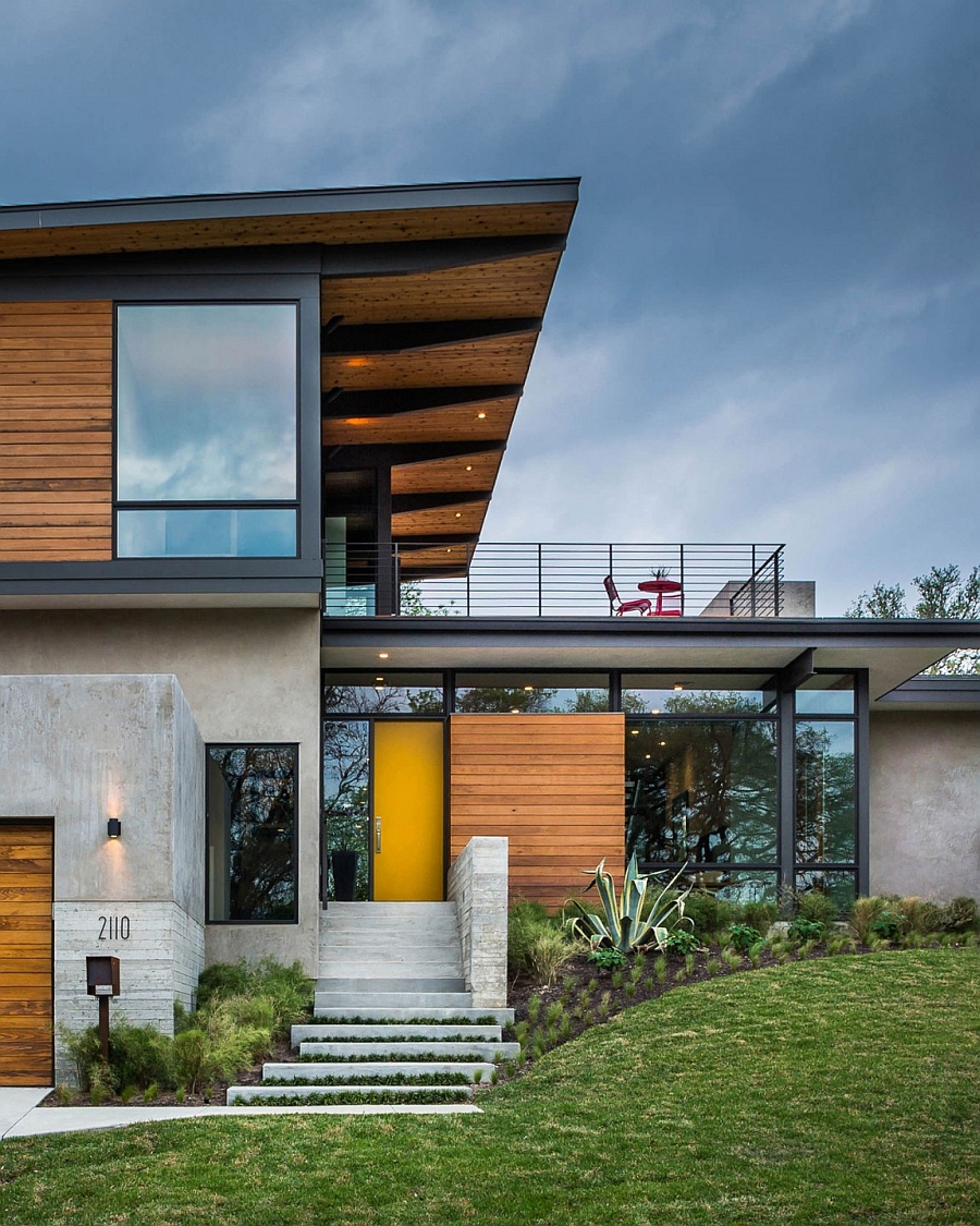 Colorful front door in yellow welcomes you at the cool Texas Home