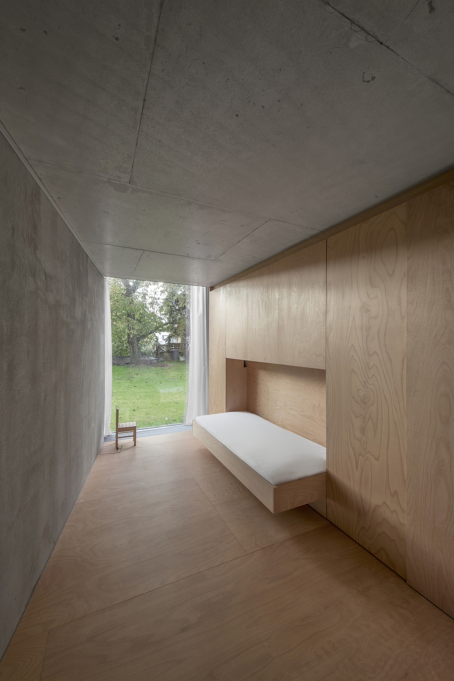 Concrete and wood hallway leading into the living area