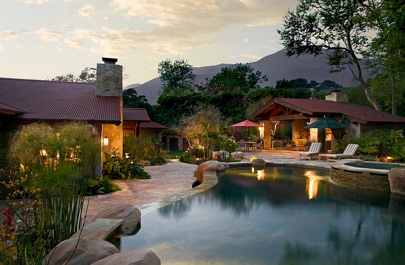 Corrugated metal roofing in the backyard adds to the dreamy appeal of this natural pool setting