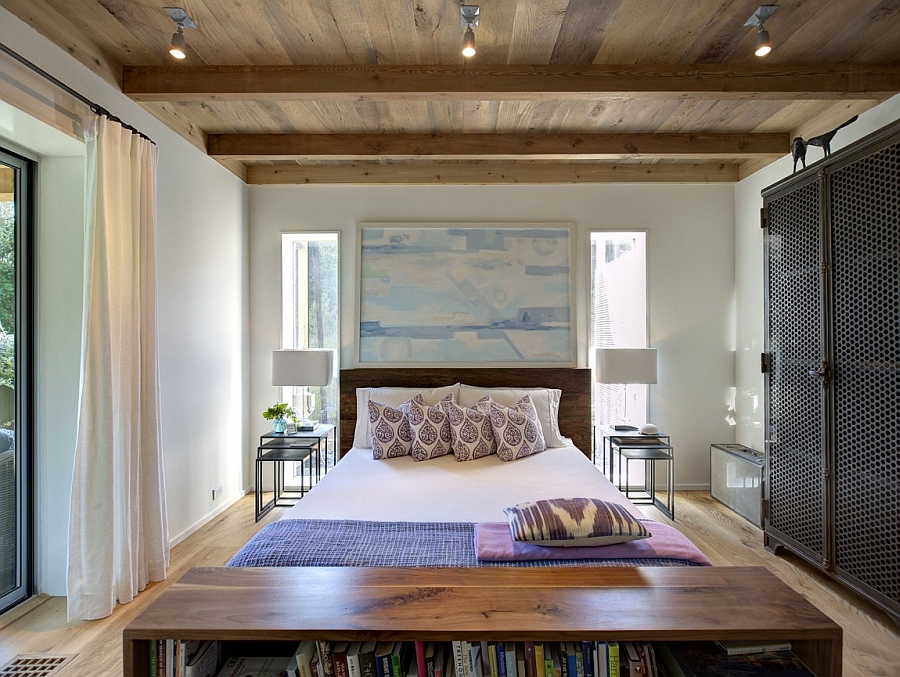 Cozy bedroom with white walls and a ceiling clad in wood