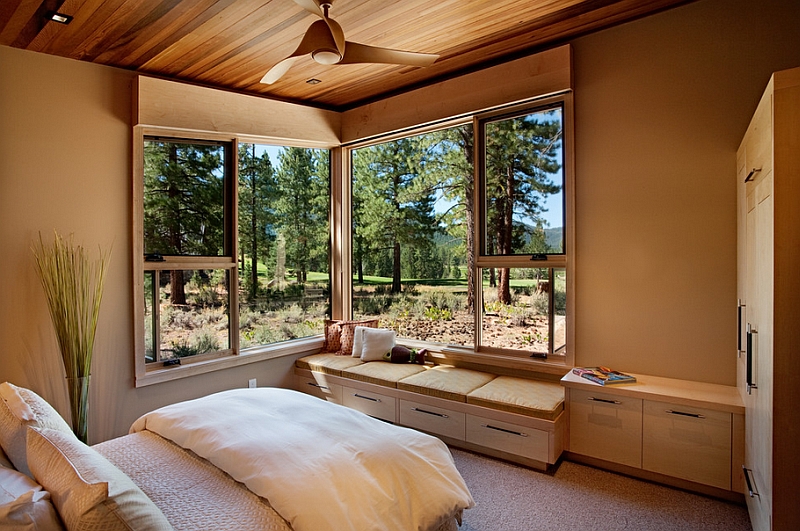 Cozy daybed in the corner next to the stylish corner window of the bedroom