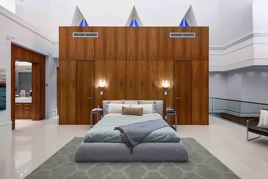 Elegant master bedroom of the penthouse with a wooden accent addition